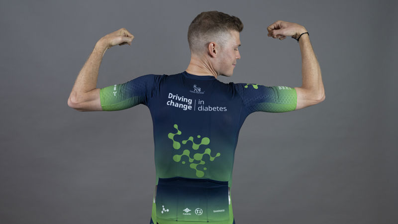 A navy and green Team Novo Nordisk jersey. On the top there is a Novo Nordisk logo, underneath it